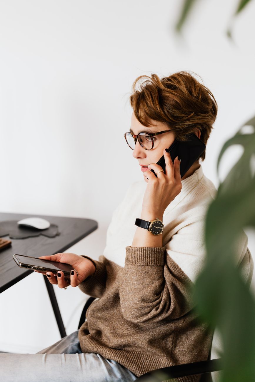 Professional on the phone at a desk, representing the Corvo Impact recruiting team